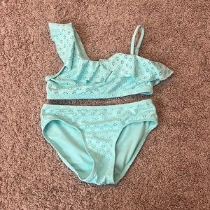 This is a Justice bathing suit in the color teal size is a L 12/14